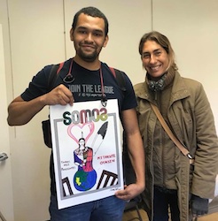 Artist Teresa Fernandez with a community member holding a poster