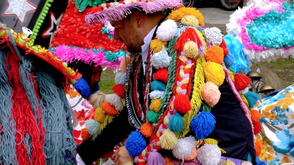 An individual wearing a traditional Slavic colorful garment.