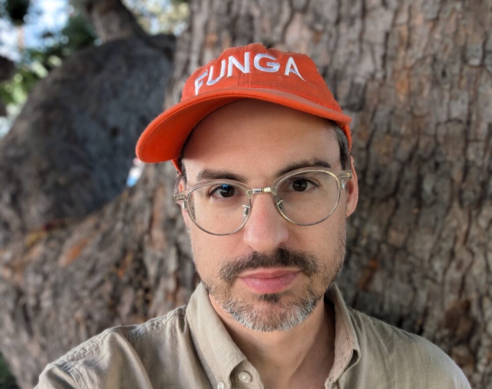 portrait of artist Ben Kinsley with red hat on that reads FUNGA