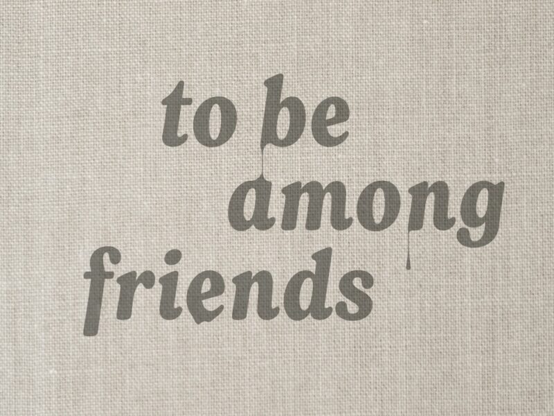 tan colored fabric with words in brown color that read to be among friends